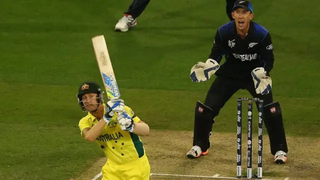 Michael Clarke bats at Luke Ronchi looks on