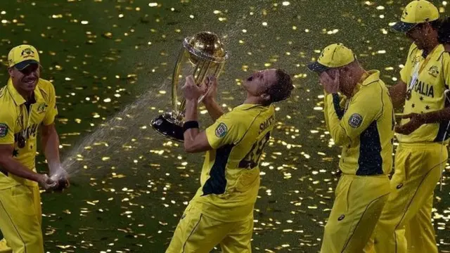 David Warner (L) sprays champagne on team-mate Steve Smith