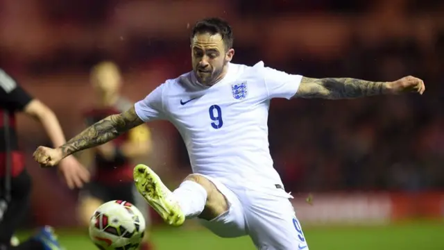 Danny Ings challenges for the ball