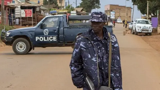 Police stand guard at the scene where acting assistant director of public prosecution Joan Kagezi was shot dead in a suburb in Kampala, Uganda, 31 March 2015