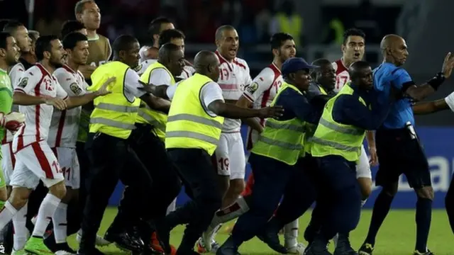 Referee Rajindraparsad Seechurn is confronted by Tunisia players after the game against Equatorial Guinea