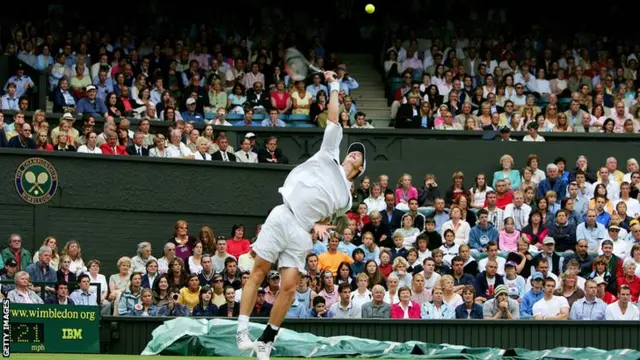 Andy Murray serves at Wimbledon in 2005