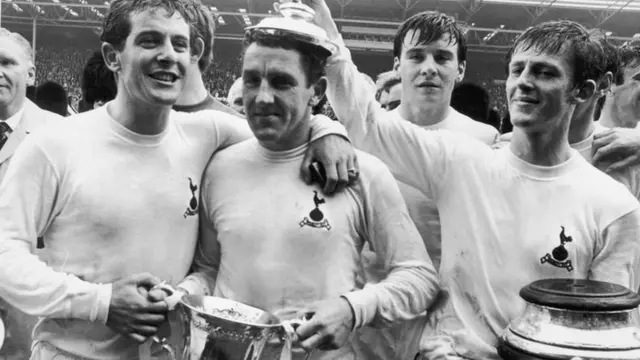 Tottenham Hotspur Captain Dave Mackay is crowned by teammate Jimmy Robertson (right) after Spurs' victory in the 1967 FA Cup final at Wembley