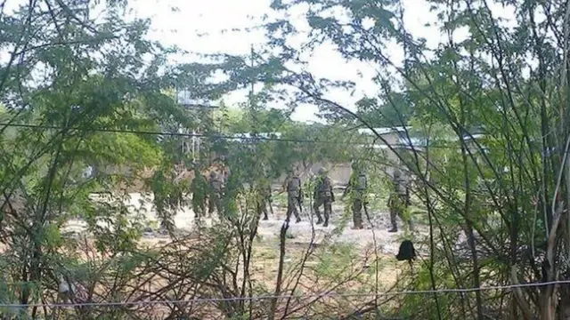 enya Defence Forces soldiers move behind a thicket in Garissa town in this photograph taken from a mobile phone 2 April 2015