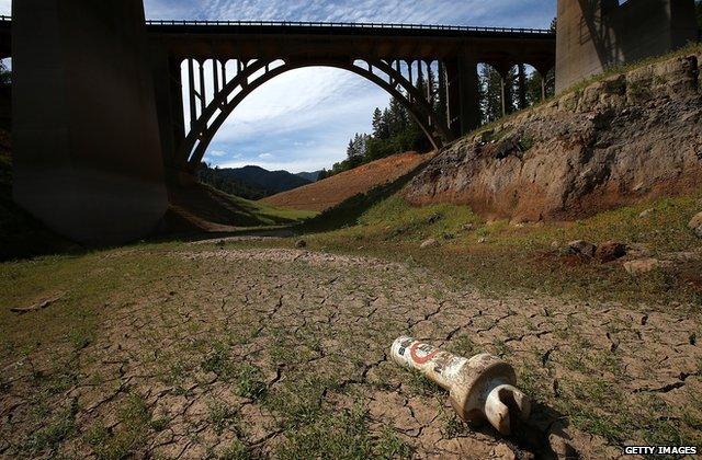 A buoy sits on dry cracked earth on a dry inlet of Shasta Lake on August 30, 2014 in Lakehead, California.