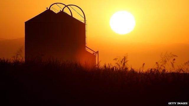 The sun rises over a farm on August 22, 2014 near Firebaugh, California.