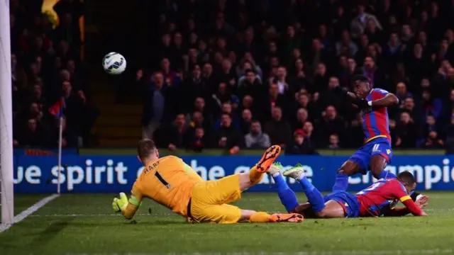 Wilfried Zaha puts an effort over the bar