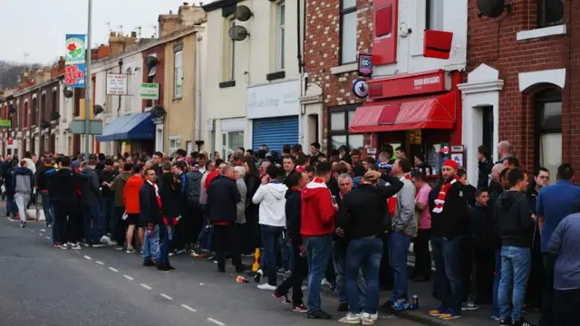 Fans waiting outside the stadium