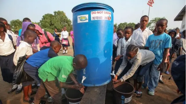 Students washing their hands as a measure to curb the spread of ebola at the SIMS Community School, Coffee farm, Caldwell, outside Monrovia, Liberia, 31 March 2015