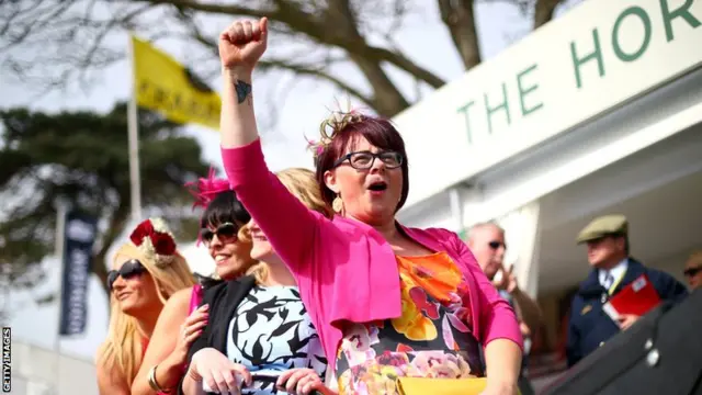 Racegoers enjoy the atmosphere during Ladies Day at Aintree