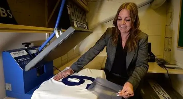 Dawn Astle prints the number nine on a special commemorative shirt