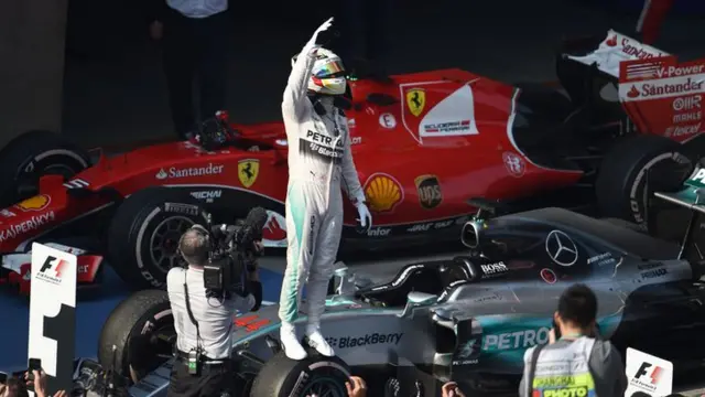 Lewis Hamilton celebrates after winning in China