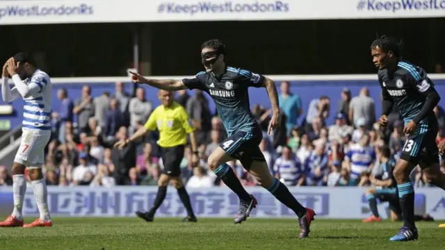 Cesc Fabregas celebrates after scoring the winning goal against QPR