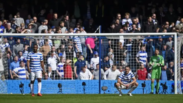 QPR's players look on dejected after conceding a late goal