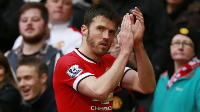 Michael Carrick applauds the Manchester United supporters