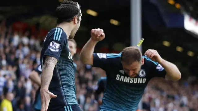 A cigarette lighter can clearly be seen striking Chelsea defender Branislav Ivanovic