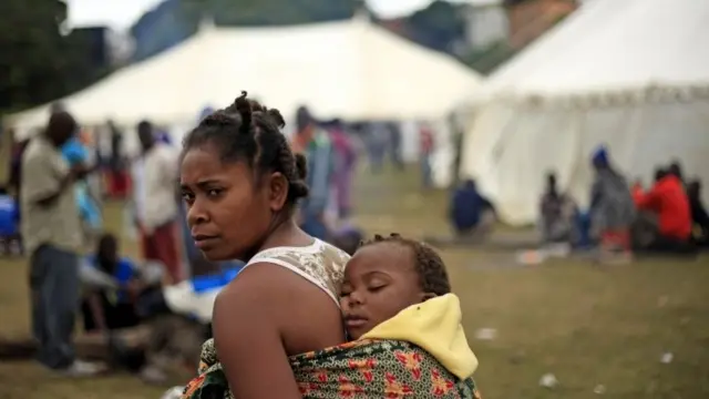 A woman makes her way through a refugee camp Wednesday