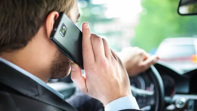 Man driving with using mobile phone