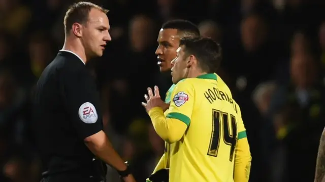 Martin Olsson speaks to referee