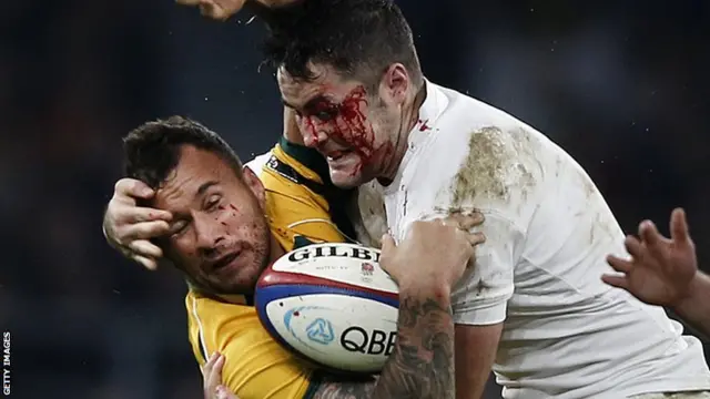 Quade Cooper is tackled by Brad Barritt