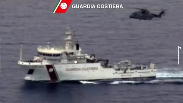 A video grab released by the Italian Coast Guards (Guardia Costiera) on April 19, 2015 showing an helicopter and a ship take part in a rescue operation off the coast of Sicily