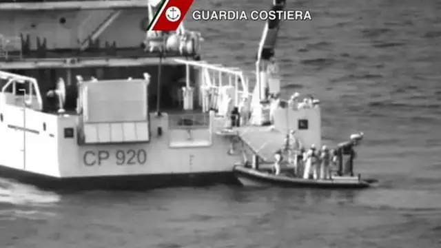 A video grab released by the Italian Coast Guards (Guardia Costiera) on April 19, 2015 showing an helicopter and a ship take part in a rescue operation off the coast of Sicily