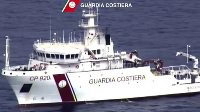 A video grab released by the Italian Coast Guards (Guardia Costiera) on April 19, 2015 showing an helicopter and a ship take part in a rescue operation off the coast of Sicily