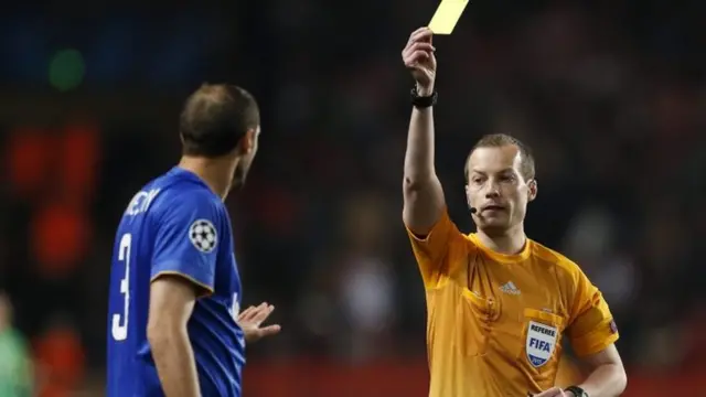 Giorgio Chiellini receives a yellow card