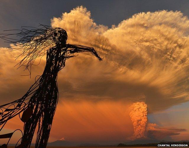 Statue with smoke cloud in the background