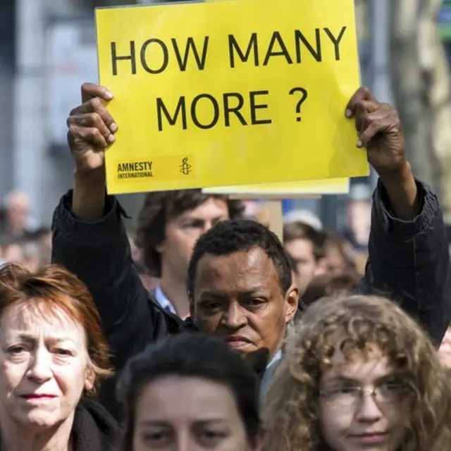 A protestor holds up a sign during a demonstration in Brussels