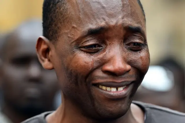 Aboubakar Soumahoro, from Ivory Coast, spokesman of the association "Sans-Papiers" in Italy cries during a demonstration of asylum seekers in front of the Italian parliament in Rome on 23 April 2015.