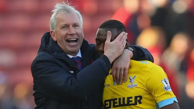 Alan Pardew of Crystal Palace shares a joke with Yannick Bolasie