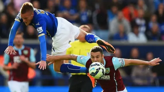 Jamie Vardy of Leicester City climbs over Jason Shackell of Burnley