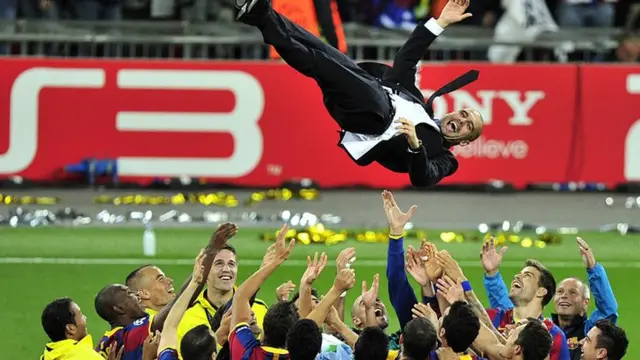 Barcelona players throw manager Pep Guardiola in the air after their 2011 Champions League win