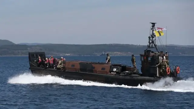 British descendants of Gallipoli troops approach the Turkish shore by landing craft