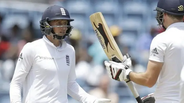 Joe Root, left, talks to team-mate James Anderson