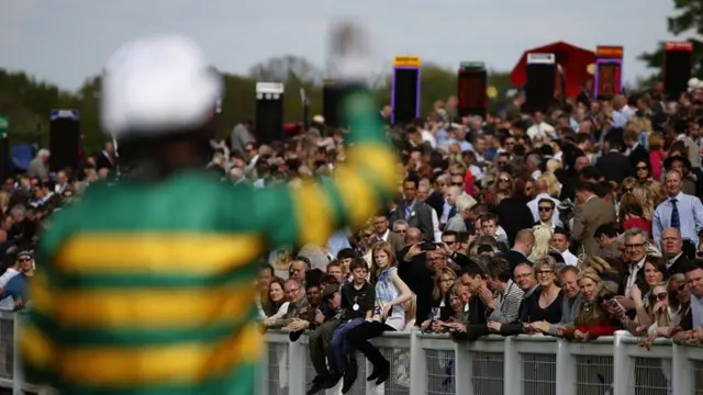 AP McCoy waves to the crowd at Sandown