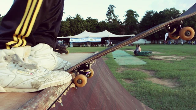 Skateboarder preparing to leap off the ramp