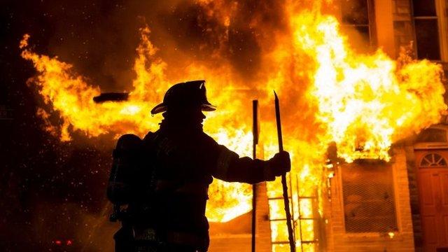 Baltimore fire-fighters battle a blaze in west Baltimore on Monday