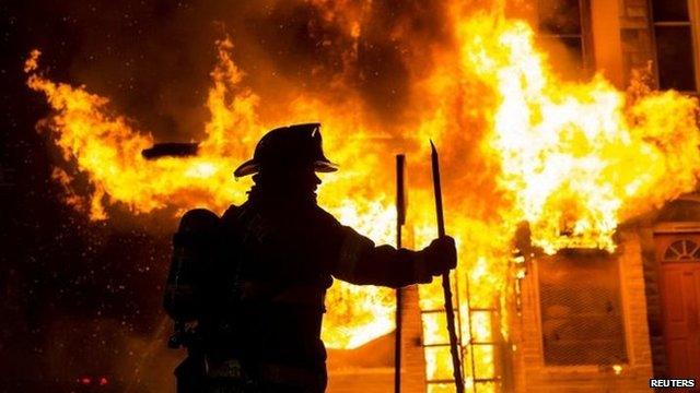 Baltimore fire-fighters battle a blaze in west Baltimore on Monday