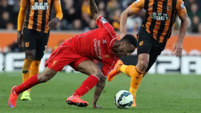 Raheem Sterling goes down for Liverpool