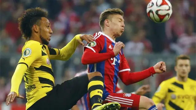 Bayern Munich's Mitchell Weiser is challenged by Borussia Dortmund's Pierre-Emerick Aubameyang