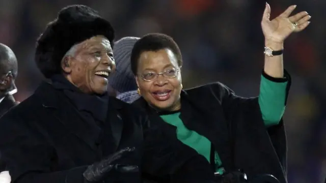 South African President Nelson Mandela, left, sits next to his wife Graca Machel as they are driven across the field ahead of the World Cup final soccer match between the Netherlands and Spain at Soccer City in Johannesburg, South Africa, 11 July 2010