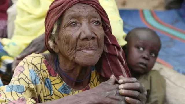 An elderly woman sits on the ground in the recently retaken town of Damasak, Nigeria, 20 March 2015