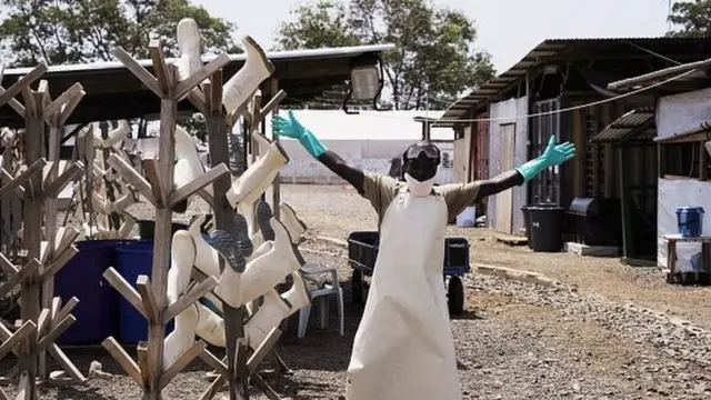 A Liberian worker reacts as he dismantles shelters in an Ebola treatment centre closed by the charity Medecins Sans Frontiers in Monrovia