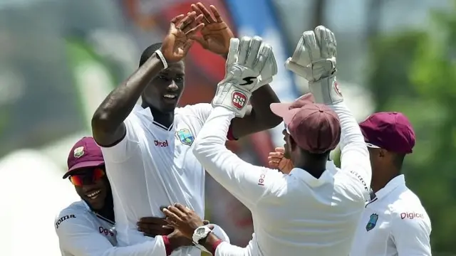 West Indies bowler Jason Holder (2nd-L) celebrates