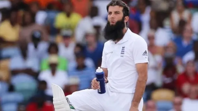 Moeen Ali looks on