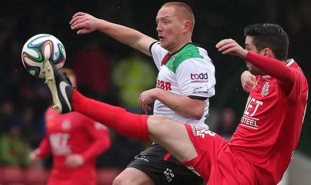 Portadown midfielder Sean Mackle gets a toe in ahead of Glentoran's Stephen Alorum