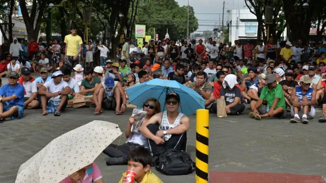 Manny Pacquiao fans watch on an outdoor screen in a Manila suburb