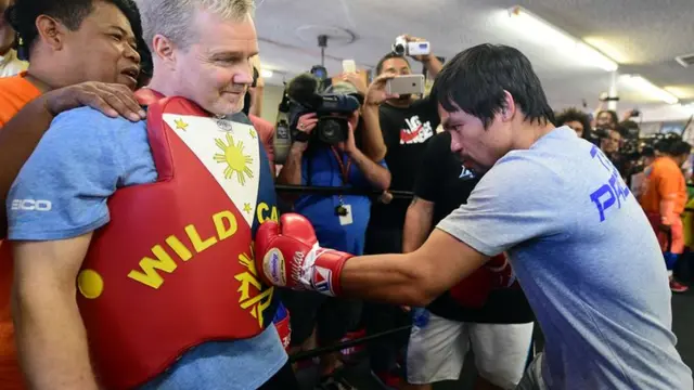 Manny Pacquiao lands a left hand on Freddie Roach